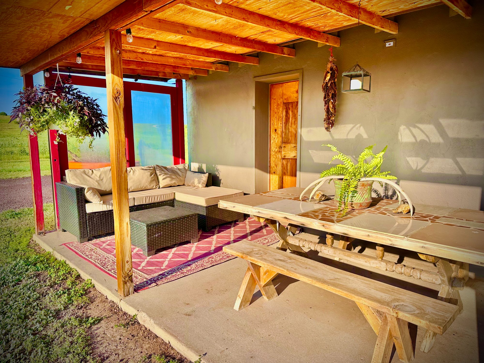 Covered porch with outdoor sectional, ristra, ranch view