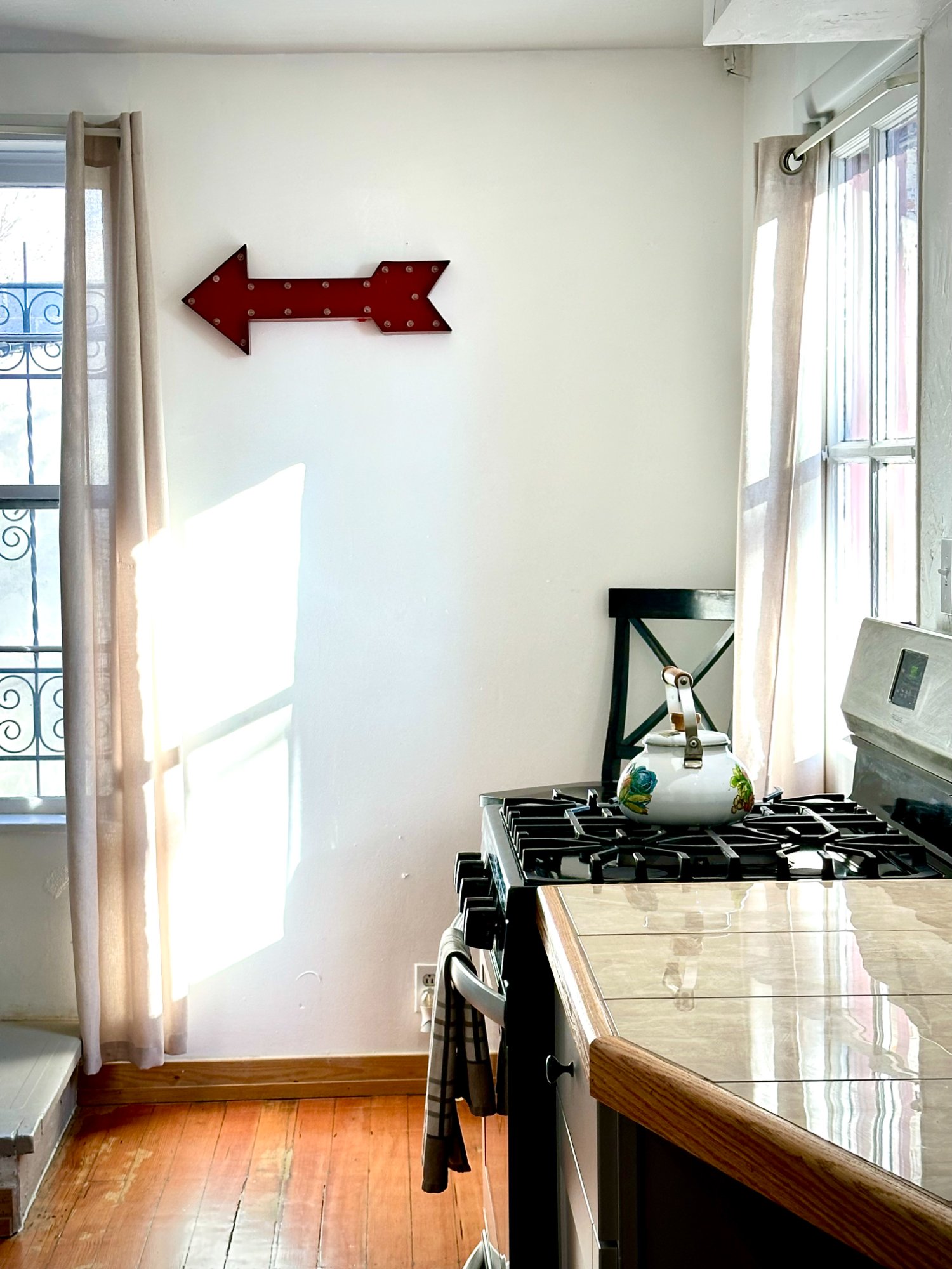 Sunny kitchen corner with red arrow sign