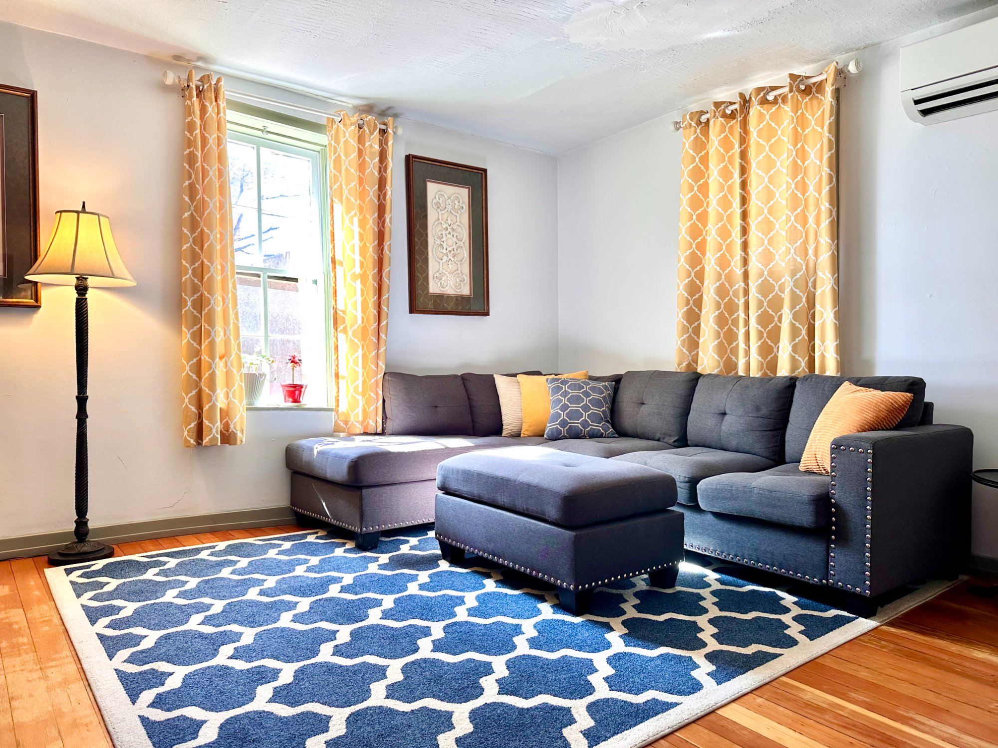 Living room with sectional and warm curtains