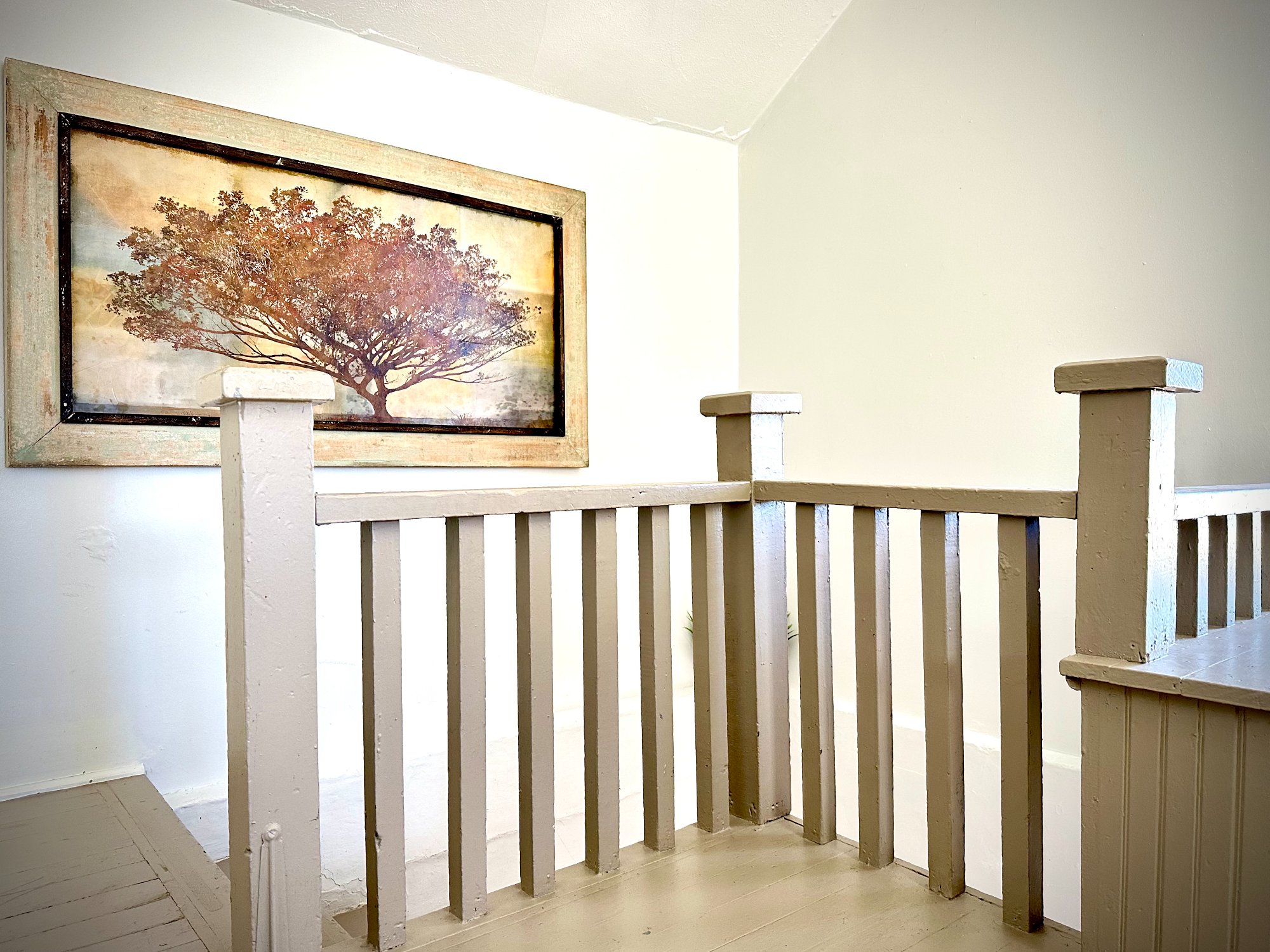 Staircase landing with tree painting