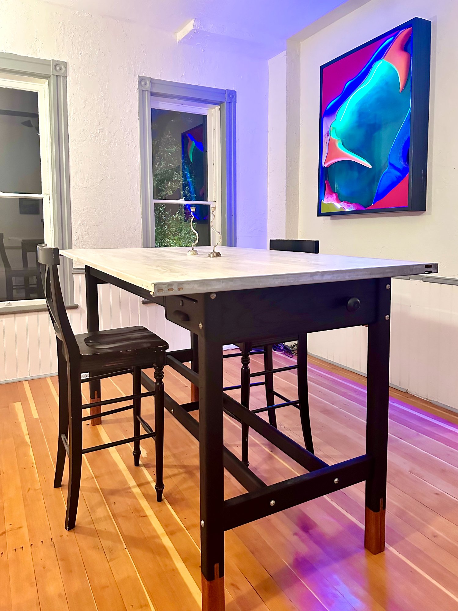 Dining table with zinc top and colorful art