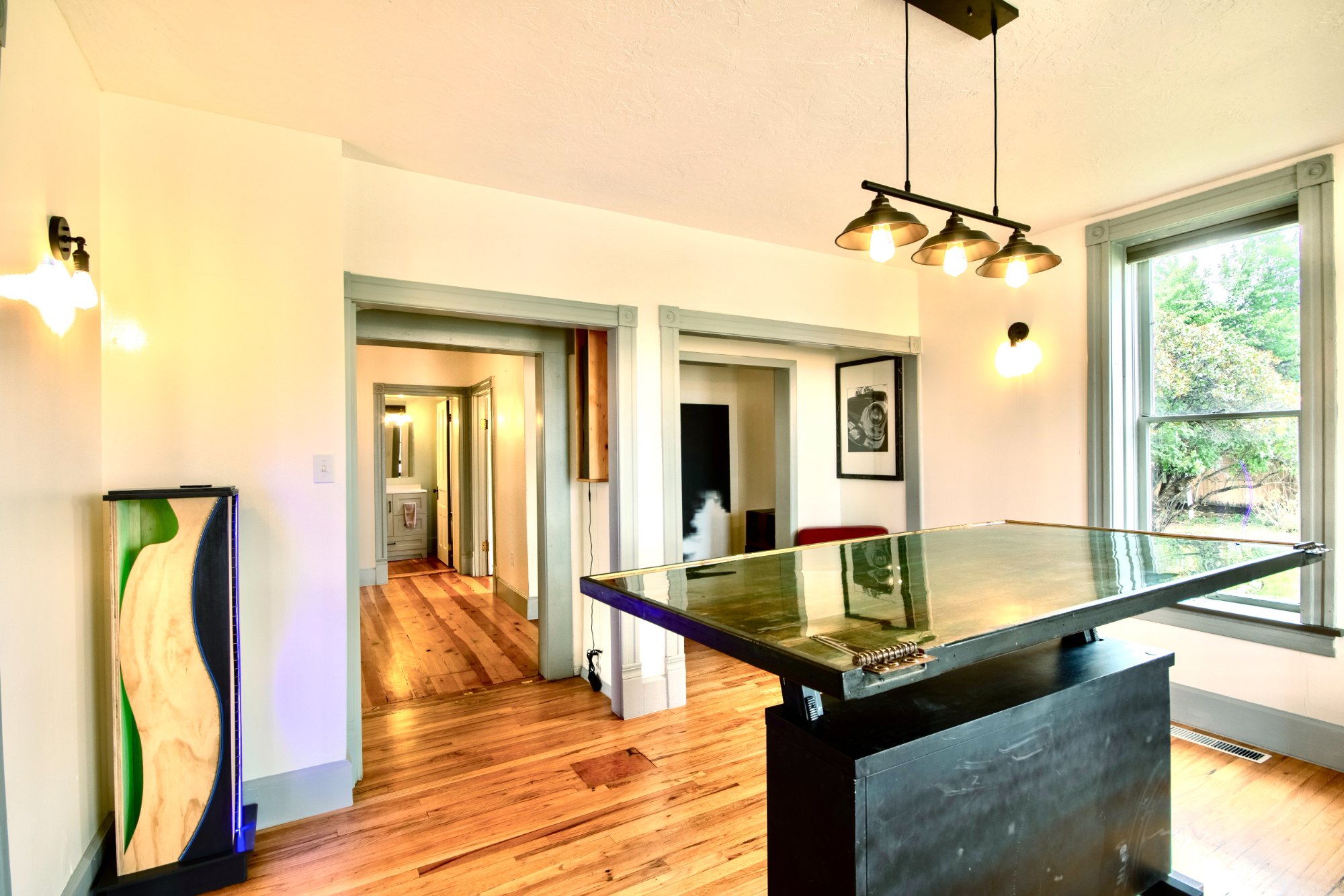 Kitchen and dining with steel island and artwork