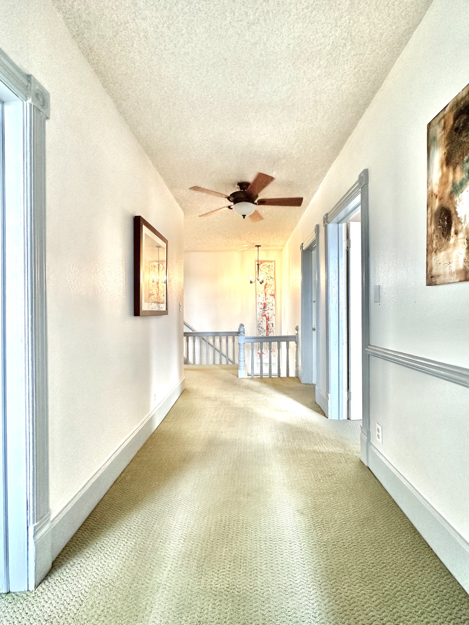 Upstairs hallway with art on walls